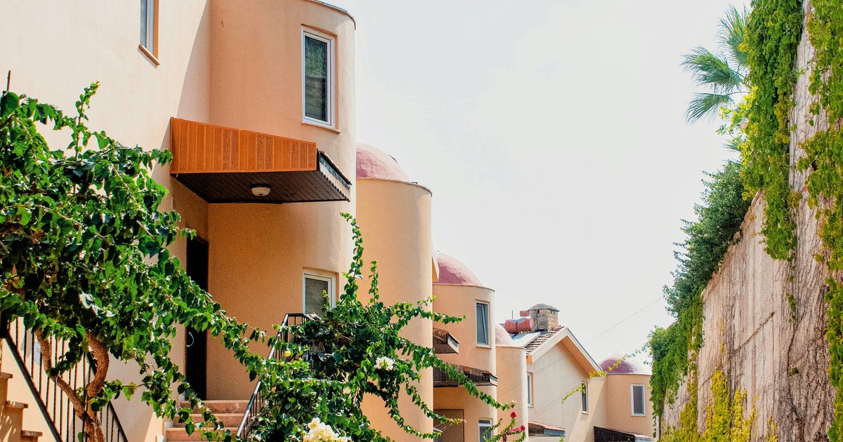 Brick and stone townhomes with garages along a landscaped street