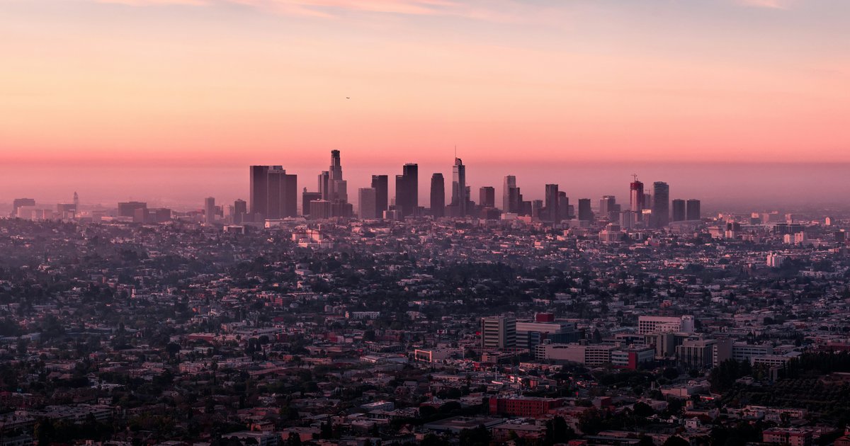 The downtown Los Angeles skyline at low sun seen across the city from the hills above Griffith Park