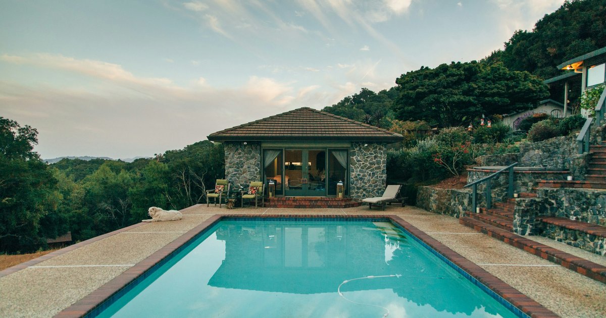Backyard pool deck overlooking a hillside canyon view, typical of Bel Air's Upper Bel Air section