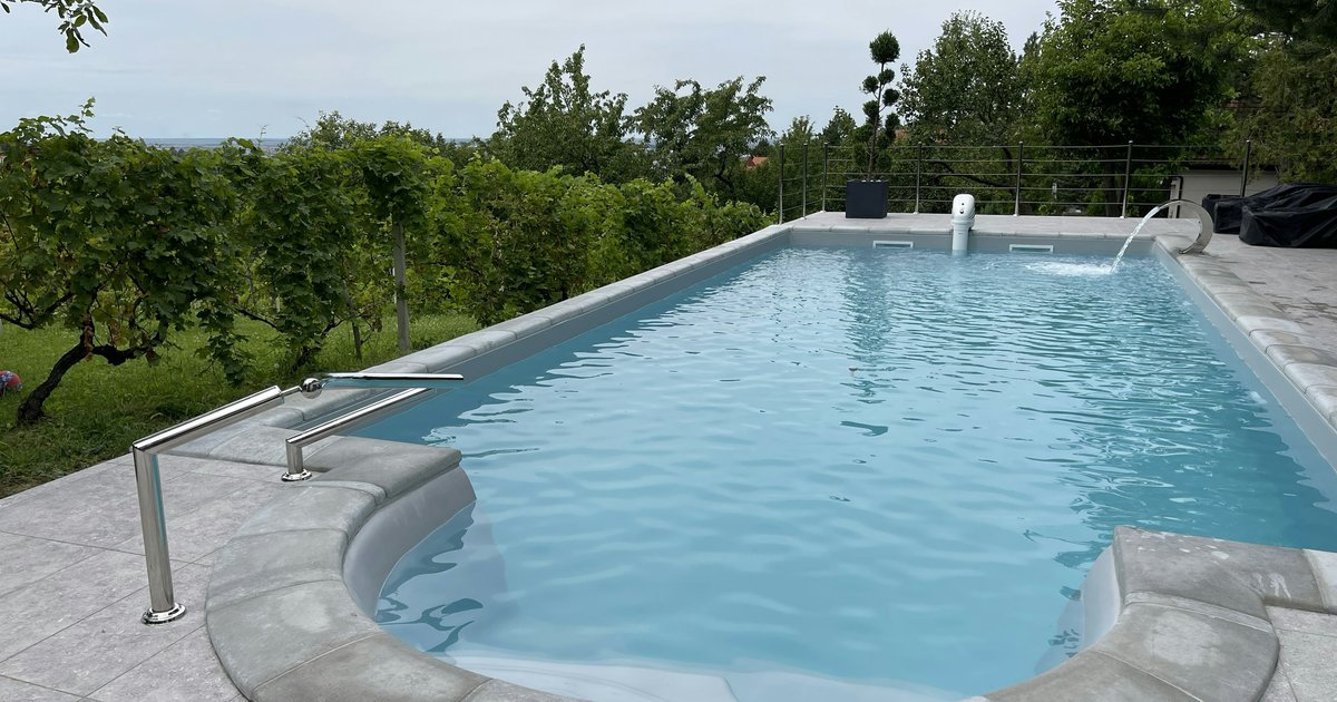 Aerial view of a stone-patio swimming pool, the kind of resort-style feature behind the summer's top Double Oak sale