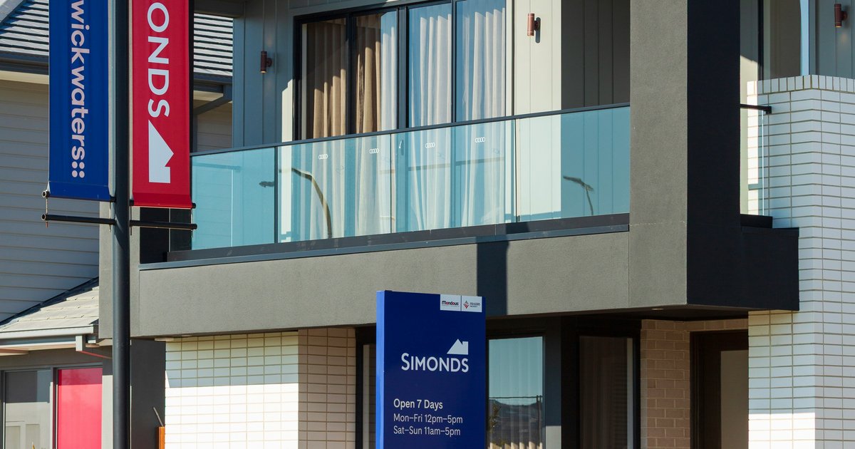 A modern DFW-area home with multiple real estate signs and flags outside, representing competitive multiple-offer situations in the Dallas market