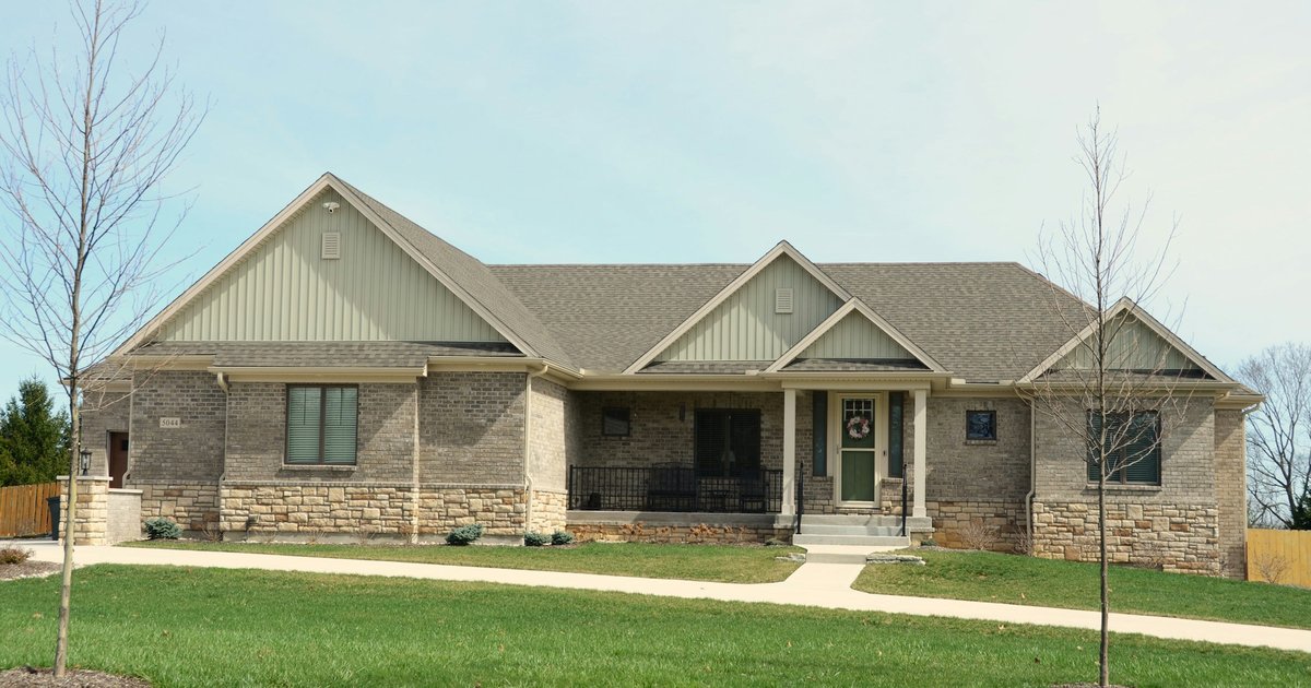 Two-story brick traditional home with a deep front lawn, typical of 1990s and 2000s North Texas suburban construction