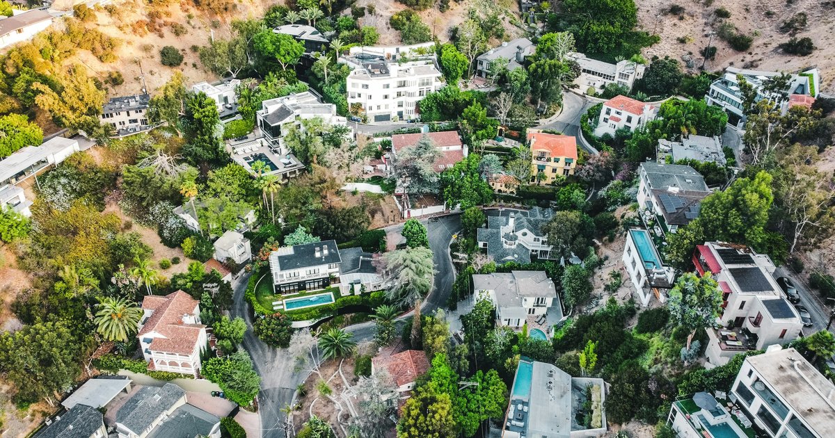 A modern home with clean lines nestled into a hillside, representing luxury Los Angeles real estate where complex title reports are common
