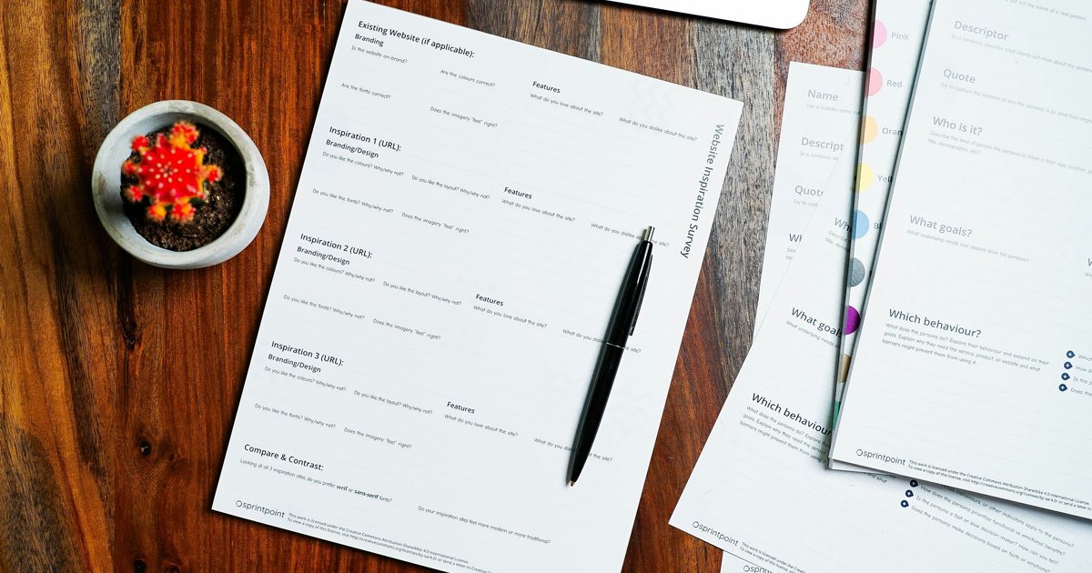 A Dallas-area home buyer reviewing loan documents with a lender, comparing mortgage pre-approval options before submitting an offer on a Collin County property
