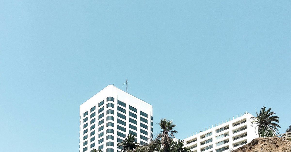 Exterior corridor of a modern Los Angeles condominium building with open-air walkways and contemporary lines