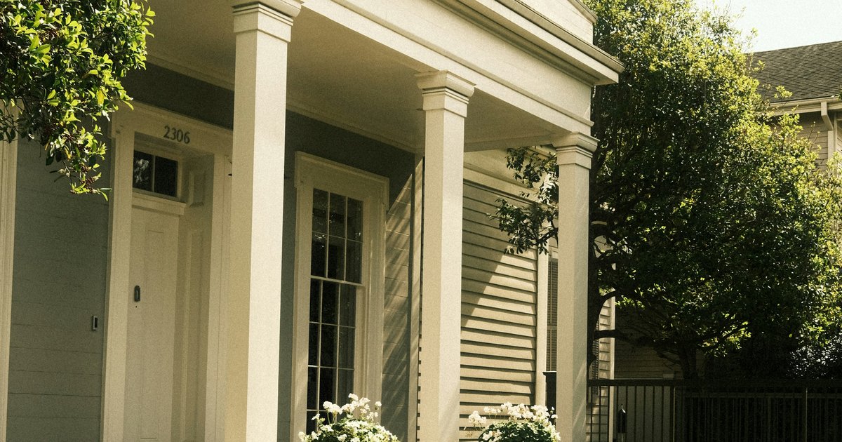 Columned front porch with mature shade trees, an example of the traditional front elevations found across North Dallas