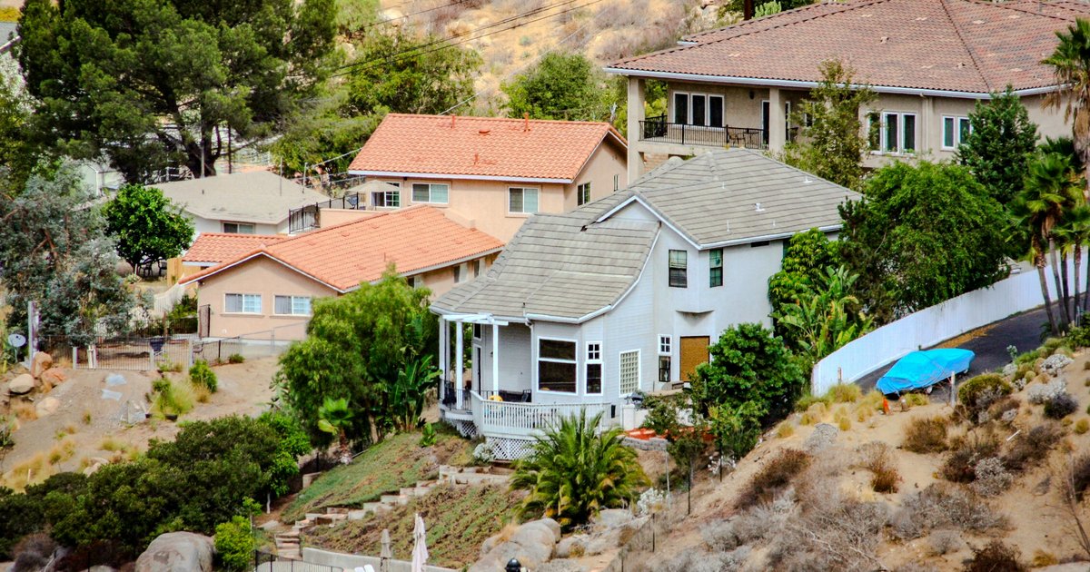 Spanish and ranch style homes set into a hillside lot in the Santa Monica Mountains foothills above Los Angeles