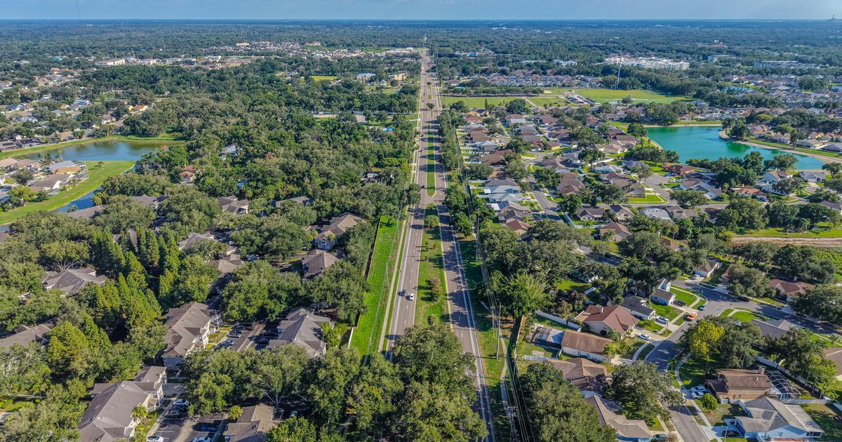 A tree-lined residential street in a north Dallas suburb, representing the mid-tier DFW neighborhoods where the SALT cap change has the most impact