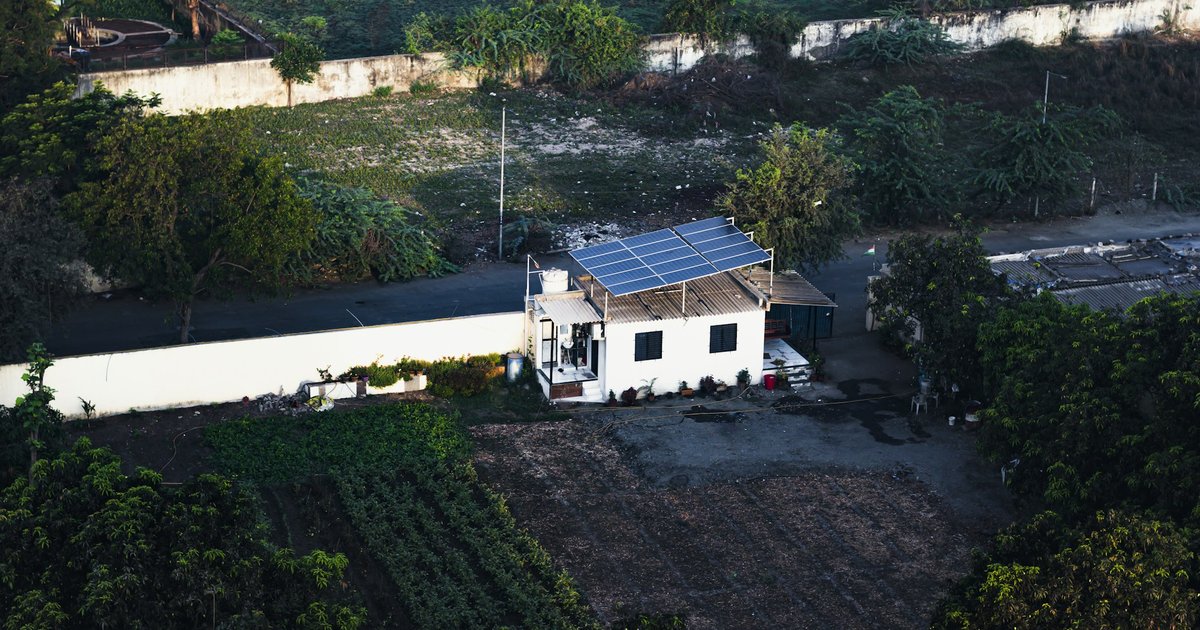 Aerial view of a single-family home with solar panels covering the south-facing roof sections, showing typical residential solar installation layout