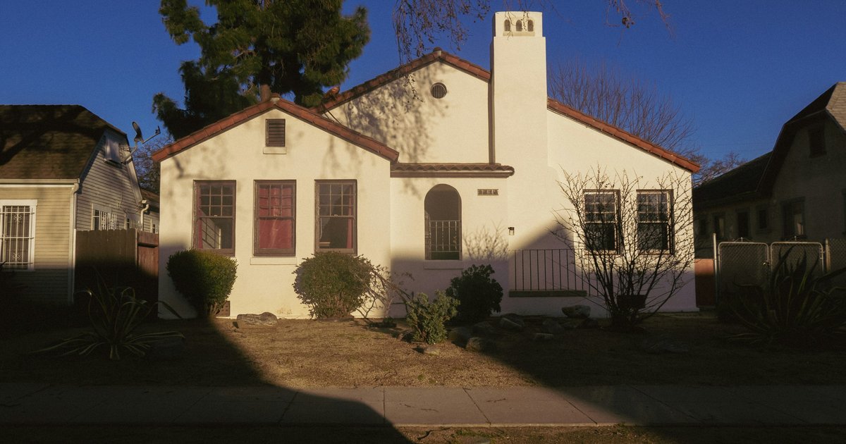 A Spanish Colonial Revival bungalow with a red tile roof, arched entry, and stucco chimney, one of the Period Revival styles found throughout Spaulding Square
