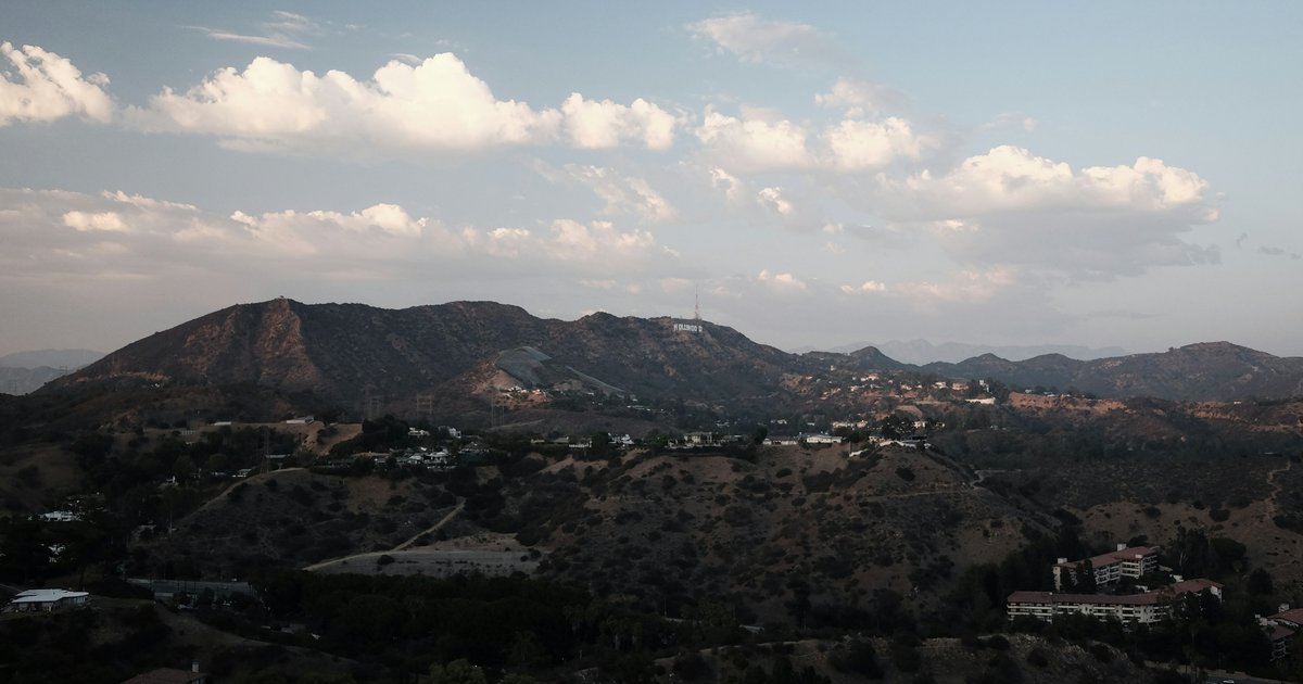 A hillside home in the Hollywood Hills with cleared brush and drought-tolerant landscaping around the structure, showing Zone 1 defensible space