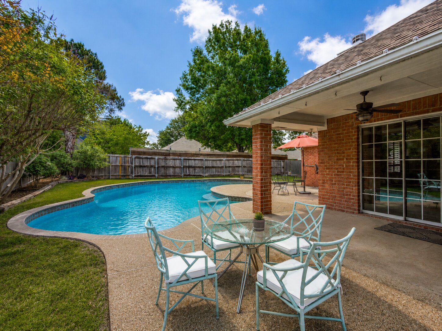 In-ground pool and covered patio at 808 Canyon Valley Drive, McKinney