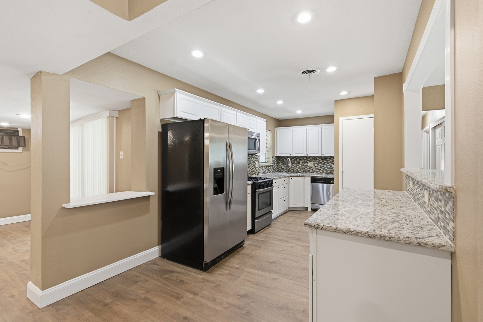 Updated kitchen with granite countertops and newer cabinetry at 3725 Sheryl Drive, Mesquite